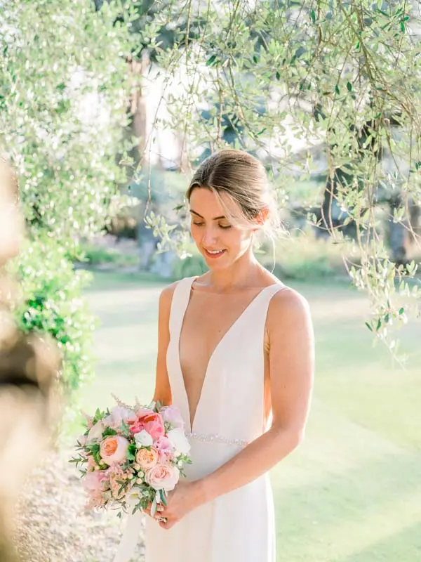 Bride with her bouquet beneath an olive tree, Château Pape Clément