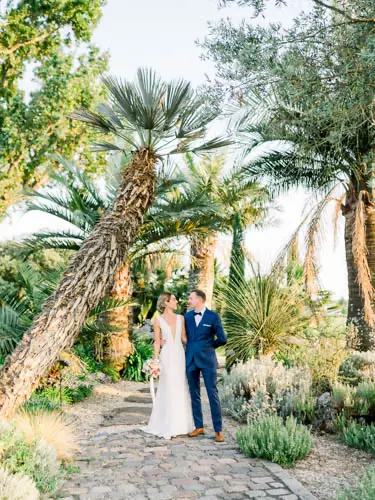 Bride and groom in the exotic garden of Château Pape Clément