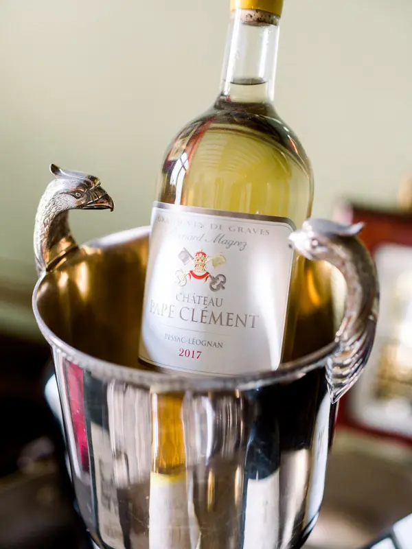 Bottle of Château Pape Clément white wine in a silver ice bucket