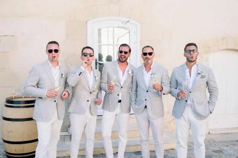 Groomsmen in light suits at Château Pape Clément