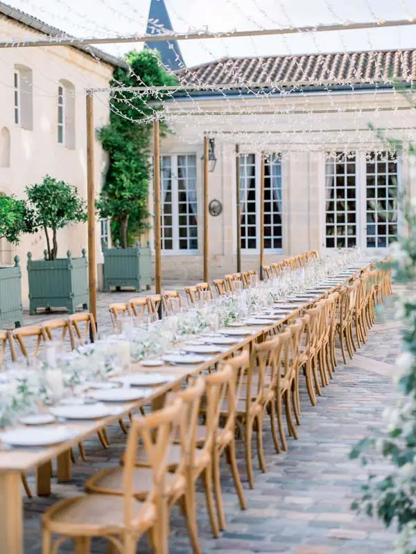 Long wedding table in the courtyard of Château Pape Clément