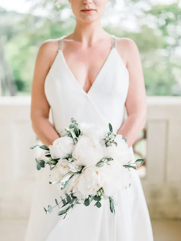 Bride holding a white peony bouquet