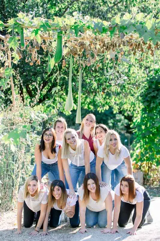 Friends forming a human pyramid at a hen party in the Jardin Public, Bordeaux