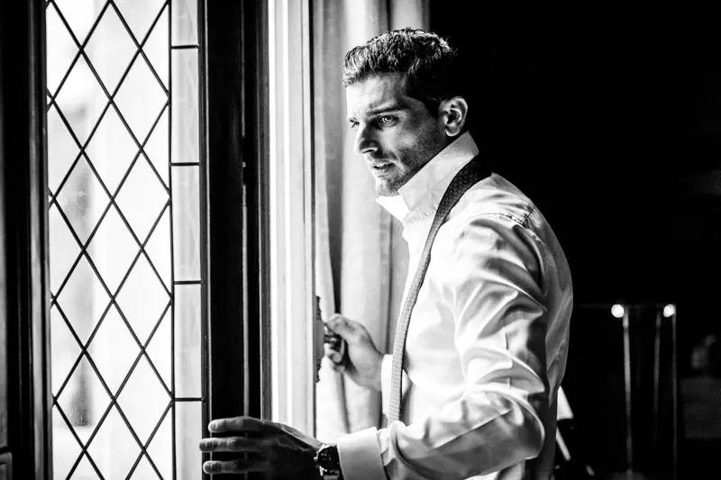 Groom by a leaded window, black and white, Château Pape Clément