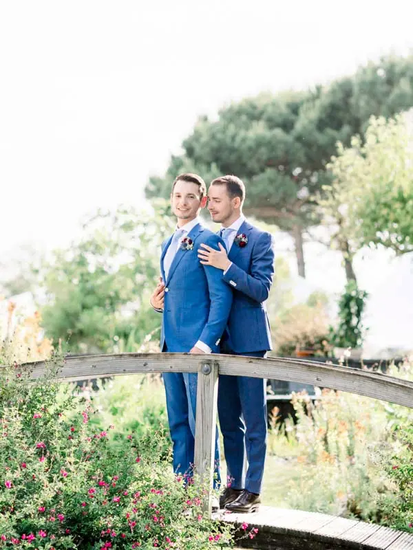 Two grooms on a garden bridge at Villa La Tosca