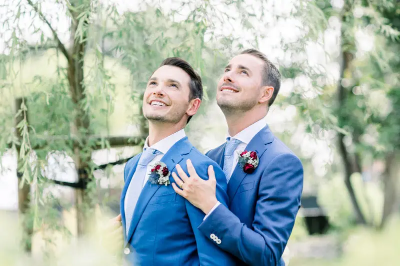 Two grooms in blue suits at their Villa La Tosca wedding