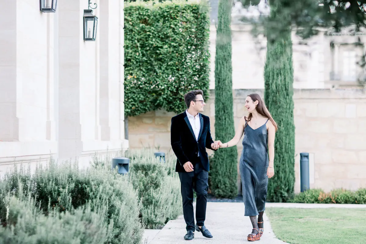 Couple walking hand in hand through the gardens of La Grande Maison Bernard Magrez in Bordeaux