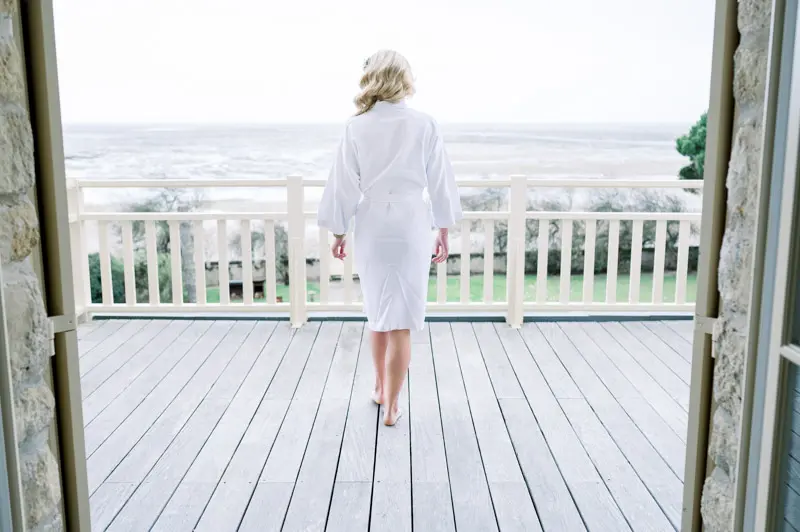 Bride in a robe on the balcony overlooking Arcachon Bay