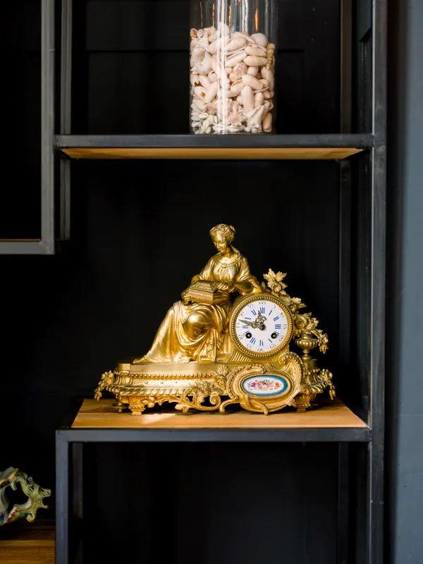 Gilded clock and cork jar, contemporary interior at Château de Garde