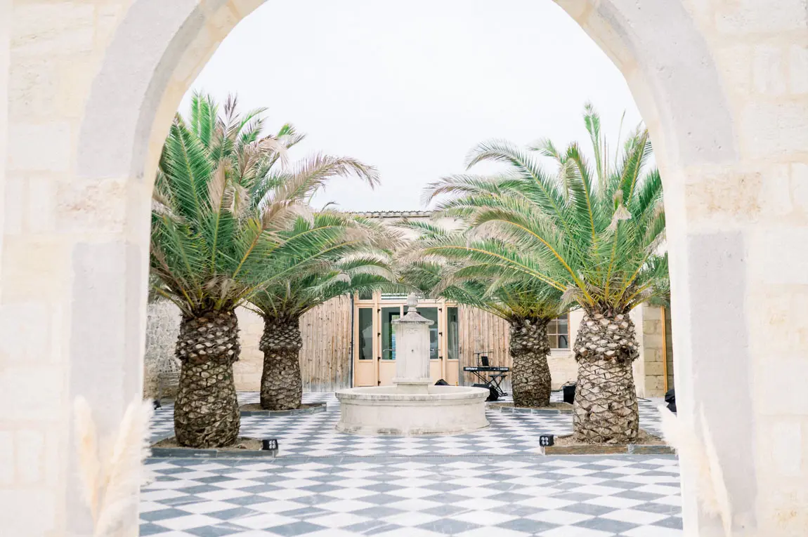 Palm-lined courtyard with a chequered floor at Château de Garde