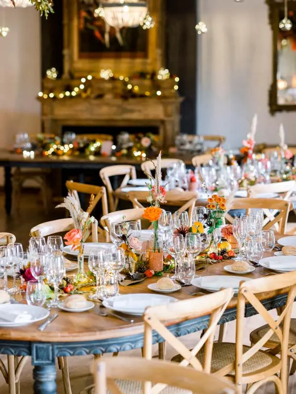 Colourful wedding table setting by the fireplace, Château de Garde
