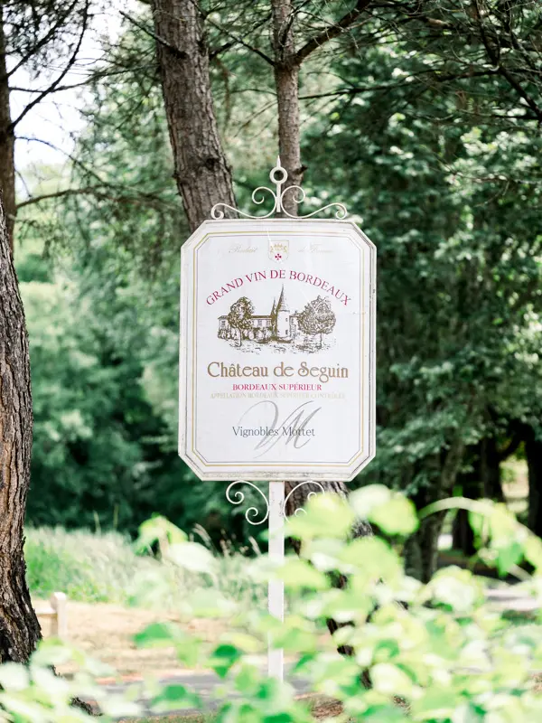 Château de Seguin estate sign among the trees