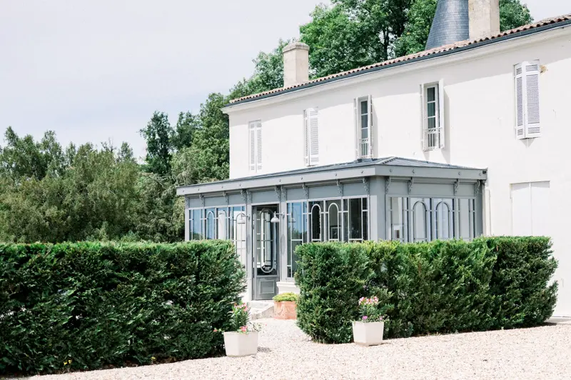 White façade and conservatory at Château de Seguin