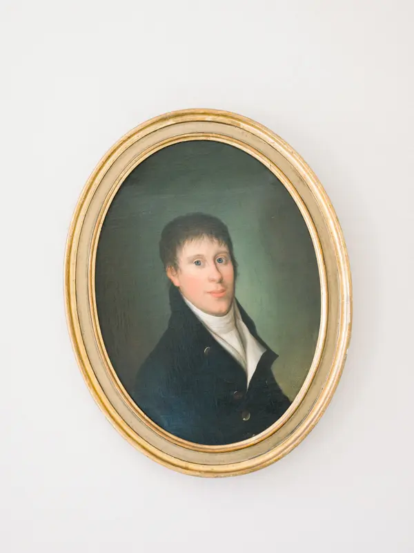 Antique portrait in a gilded frame inside Château de Seguin