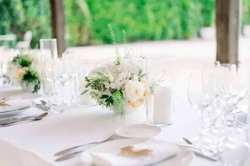 Outdoor wedding table beneath the trees at Château de Seguin