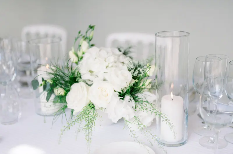 White floral centrepiece and candle, Château de Seguin wedding
