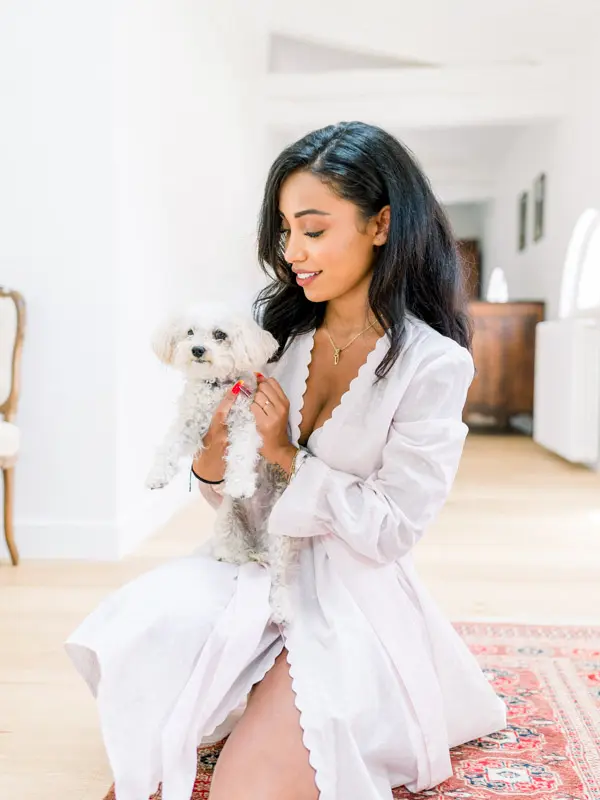 Bride in a robe holding a small dog, Château Gassies