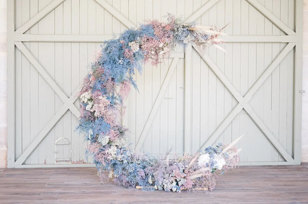 Crescent-moon floral arch at Château Gassies