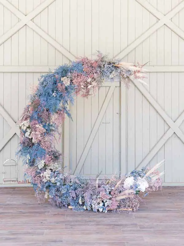 Crescent-moon floral arch at Château Gassies