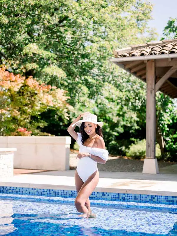 Bride stepping into the pool at Château Gassies