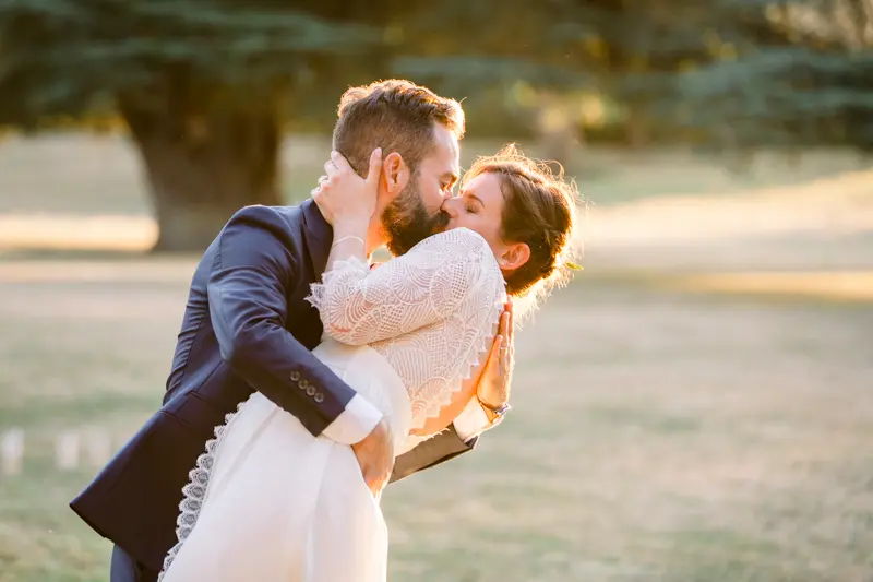 Groom lifting the bride in the park of Château de Seguin