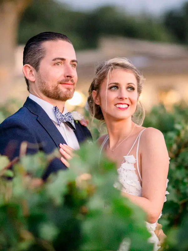 Bride and groom at golden hour in the vineyards of Château de Garde
