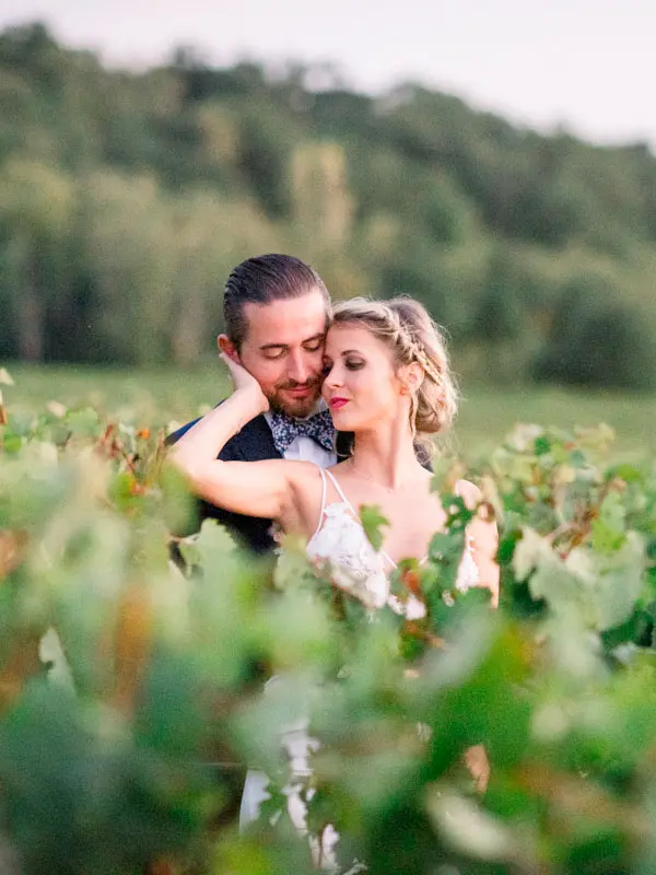 Couple embracing among the vines at Château de Garde