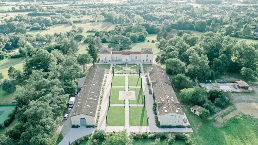 Aerial view of Château Gassies, its three buildings and French garden near Bordeaux