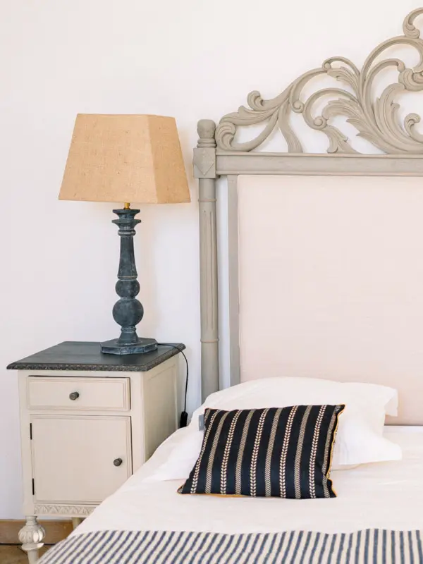Guest room with a carved headboard at Château de Garde