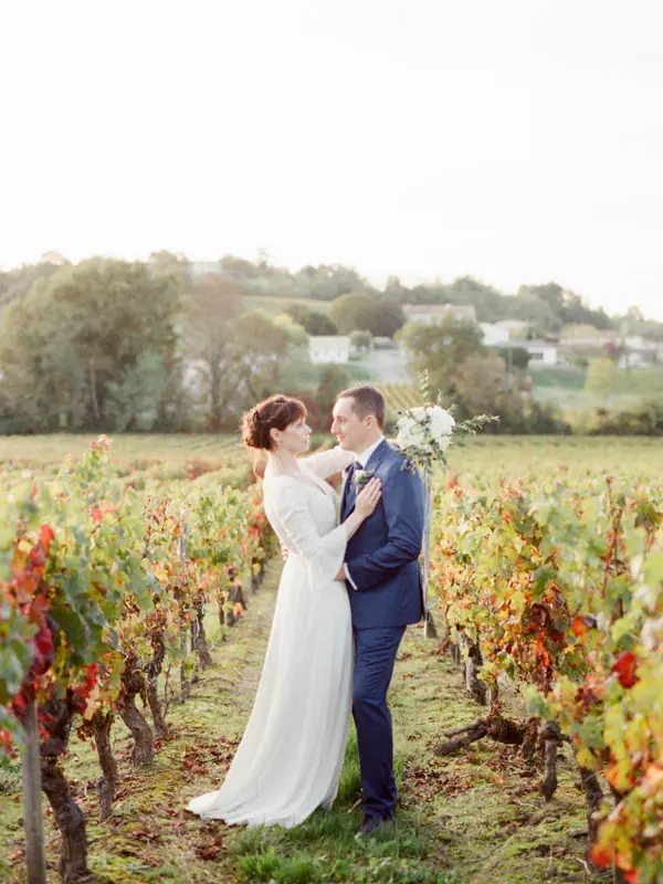 Bride and groom in the autumn vineyards of Château de Garde