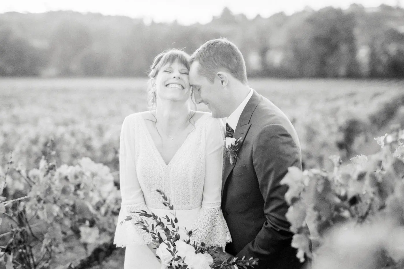 Black and white portrait of a laughing couple in the vineyards