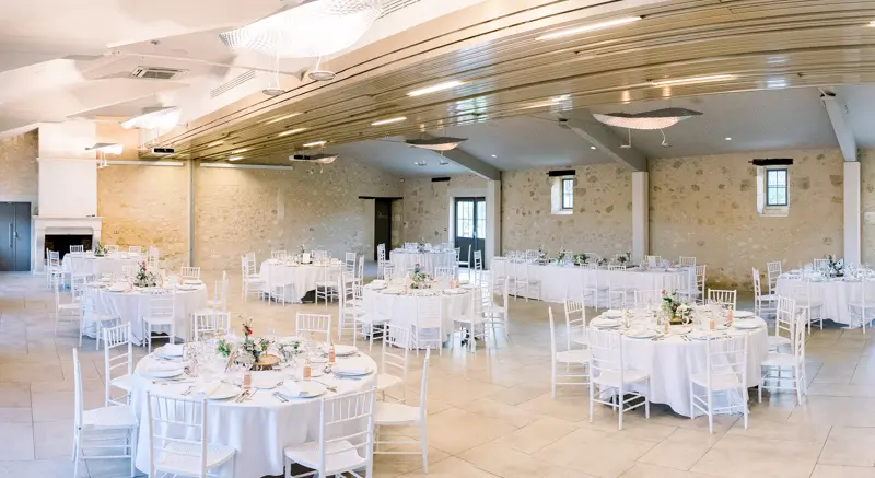 Reception hall set with round tables at Château de Seguin