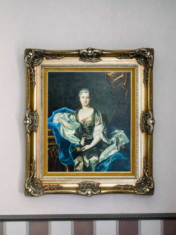Antique portrait in a gilded frame at Domaine de Larchey