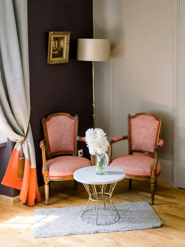 Hotel sitting room with pink armchairs at Domaine de Larchey