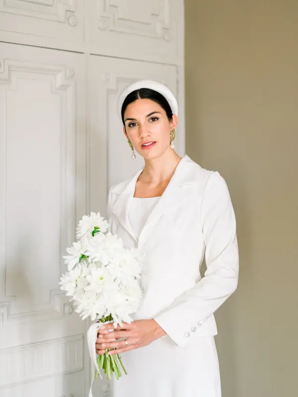 Bride in a white suit with her bouquet, Domaine de Larchey