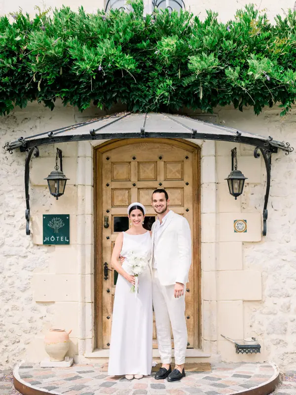 Bride and groom at the hotel door of Domaine de Larchey