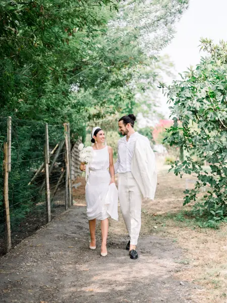 Bride and groom walking along a country path at Domaine de Larchey