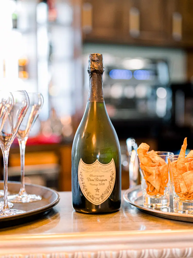 Champagne at the bar of Domaine de Larchey on the wedding morning
