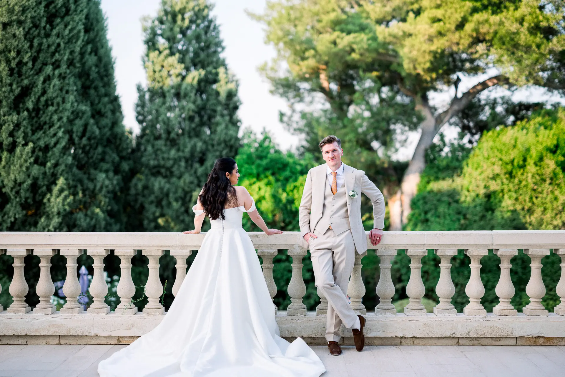 Bride and groom on a balustraded terrace at Château La Tour Vaucros, Provence
