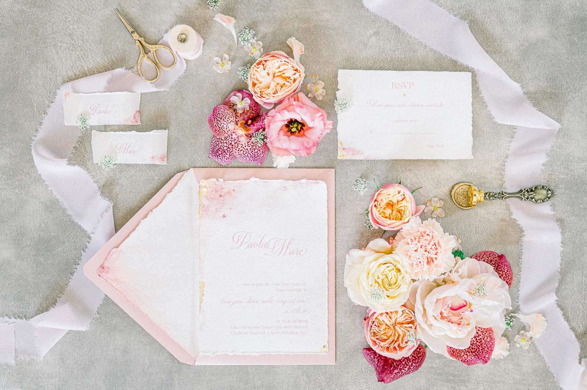 Blush wedding stationery with roses and silk ribbons, flat lay